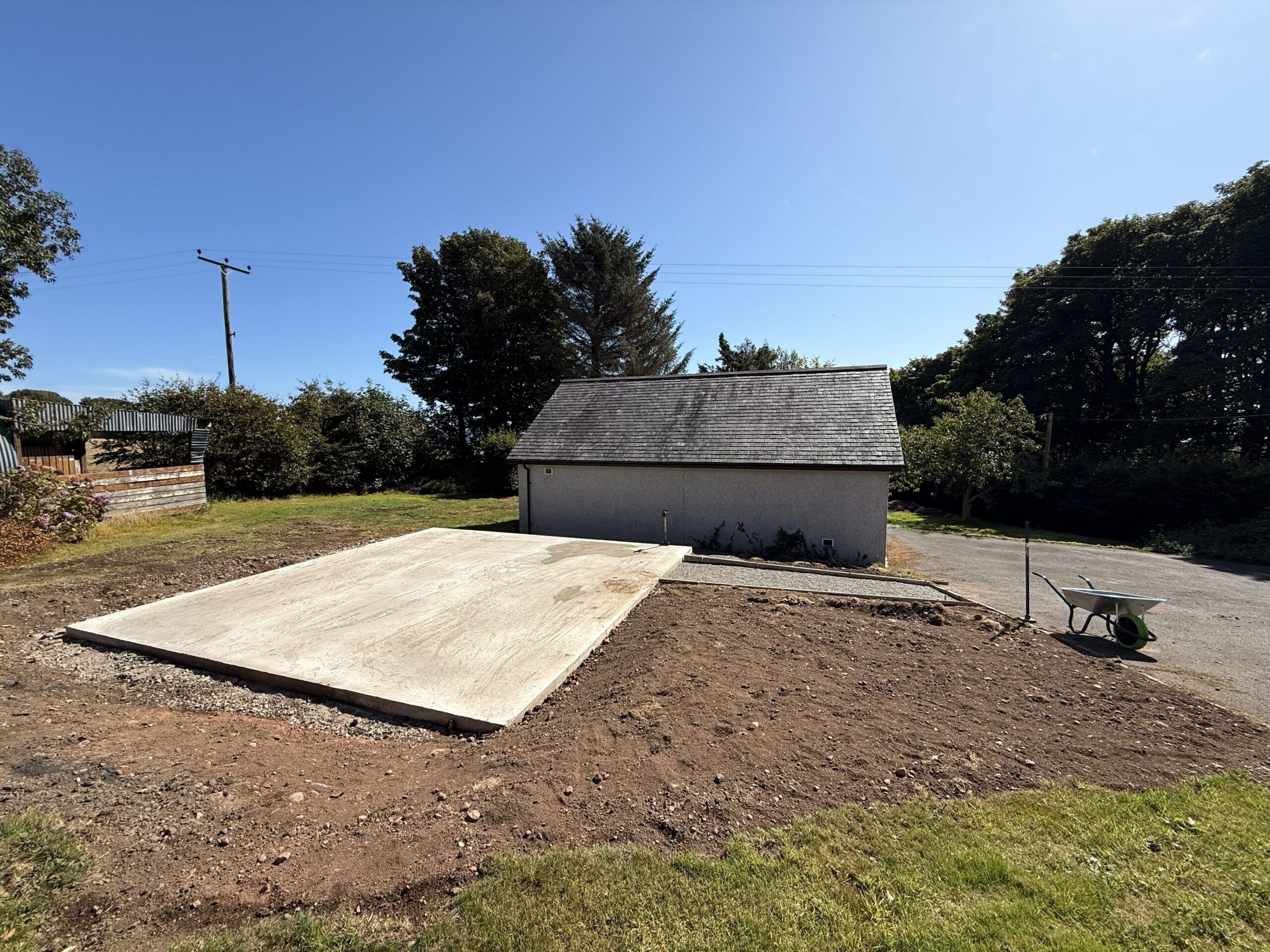 Cleared land with concrete base and shed